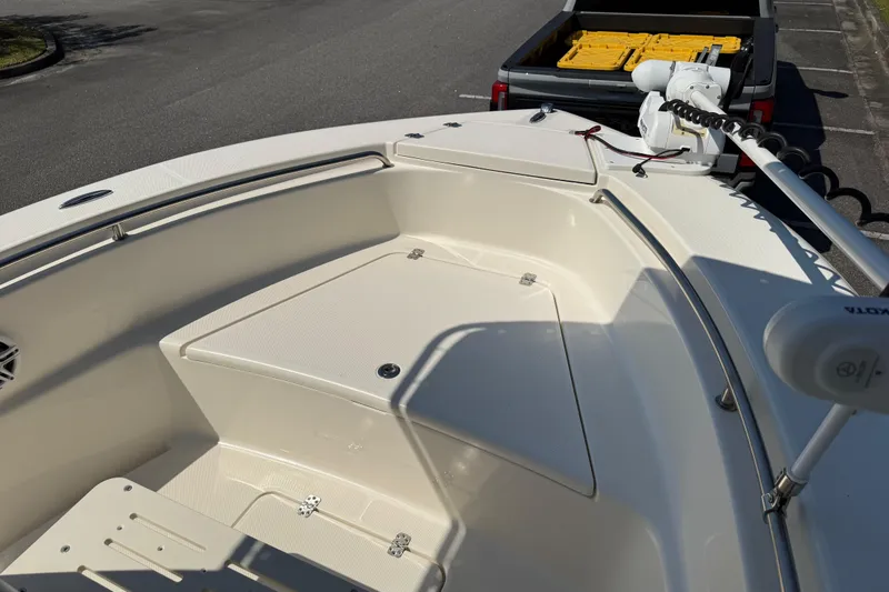 Slide: The Image of 2022 Bulls Bay 200 Center Console boat with trolling motor, parked near a truck. - 13