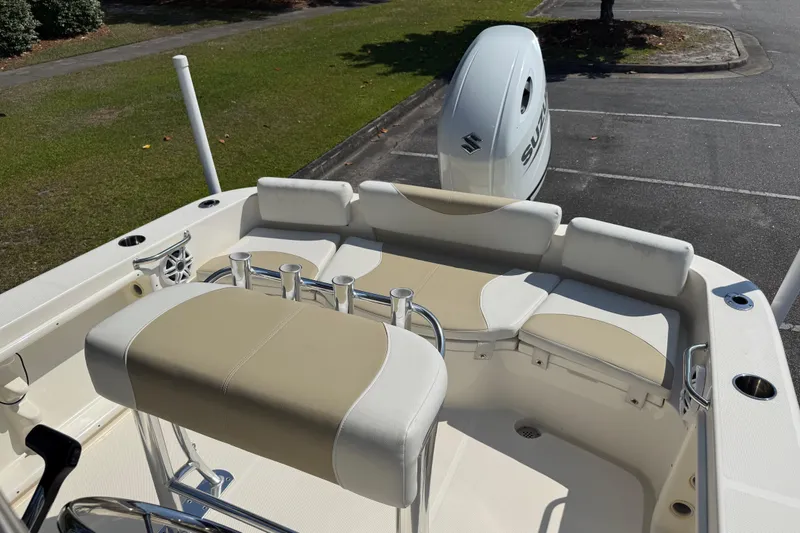 Slide: The Image of 2022 Bulls Bay 200 Center Console boat interior with seating and Suzuki outboard motor. - 18