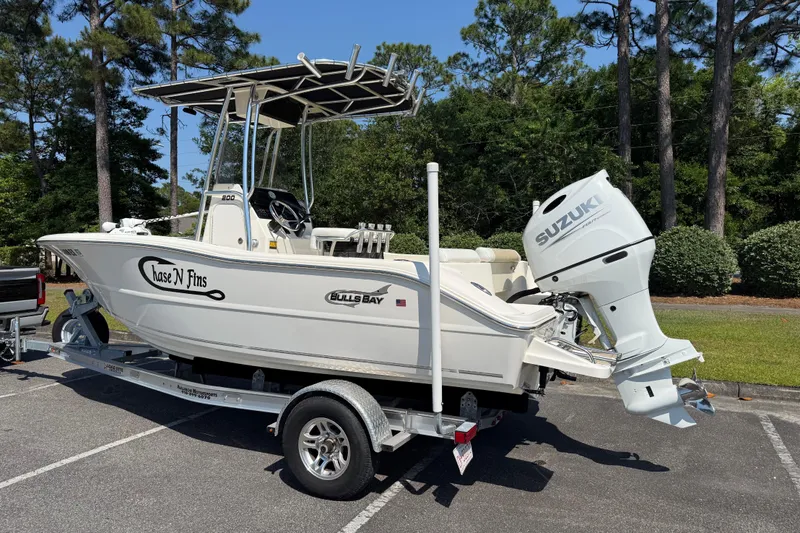 Slide: The Image of 2022 Bulls Bay 200 Center Console boat on trailer, featuring Suzuki outboard motor. - 2