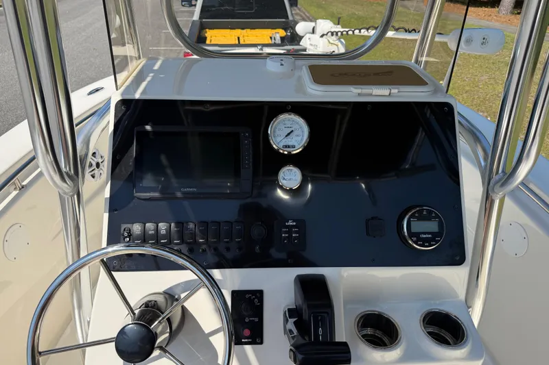 Slide: The Image of 2022 Bulls Bay 200 Center Console boat dashboard with steering wheel and navigation instruments. - 20