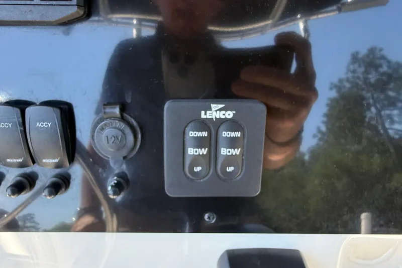 Slide: The Image of Control panel of 2022 Bulls Bay 200 Center Console boat with Lenco trim tab switches. - 23