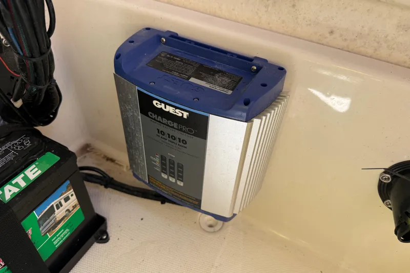 Slide: The Image of Battery charger and wiring inside a 2022 Bulls Bay 200 Center Console boat. - 26