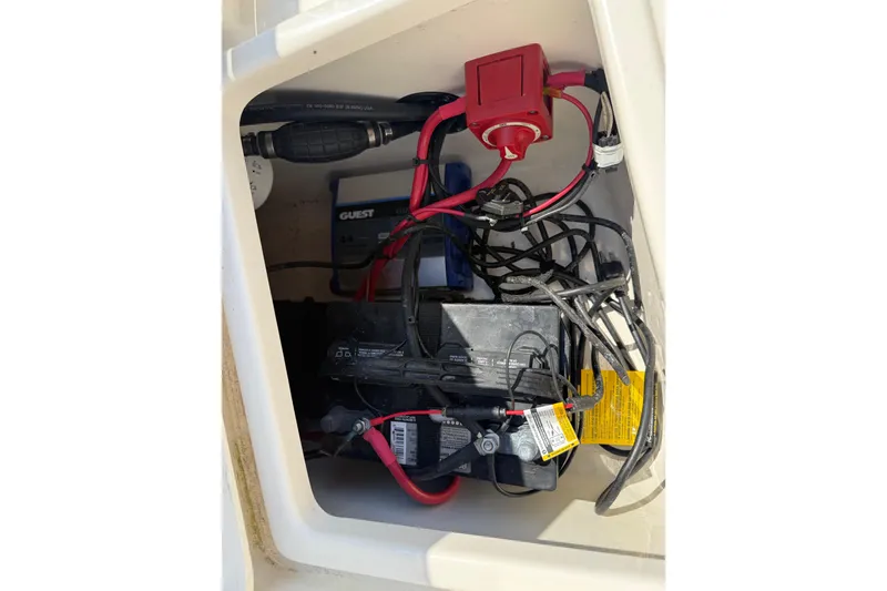 Slide: The Image of 2022 Bulls Bay 200 Center Console boat battery compartment with wiring and switch. - 27