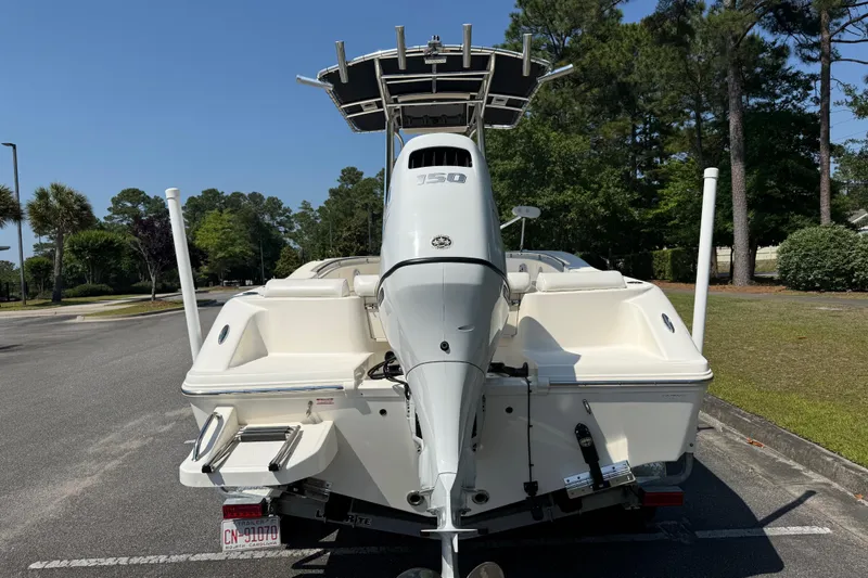 Slide: The Image of 2022 Bulls Bay 200 Center Console boat with powerful outboard motor, parked outdoors. - 4