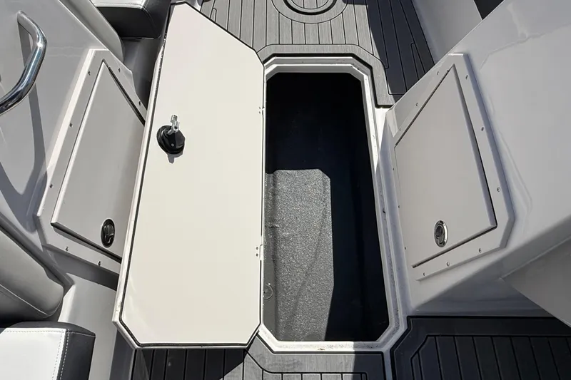 Slide: The Image of 2026 Starcraft SVX 191 OB boat storage compartment with open hatch on deck. - 11
