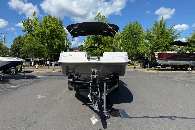 Slide: The Image of 2026 Starcraft SVX 191 OB boat on trailer, parked outdoors under a clear blue sky. - 2