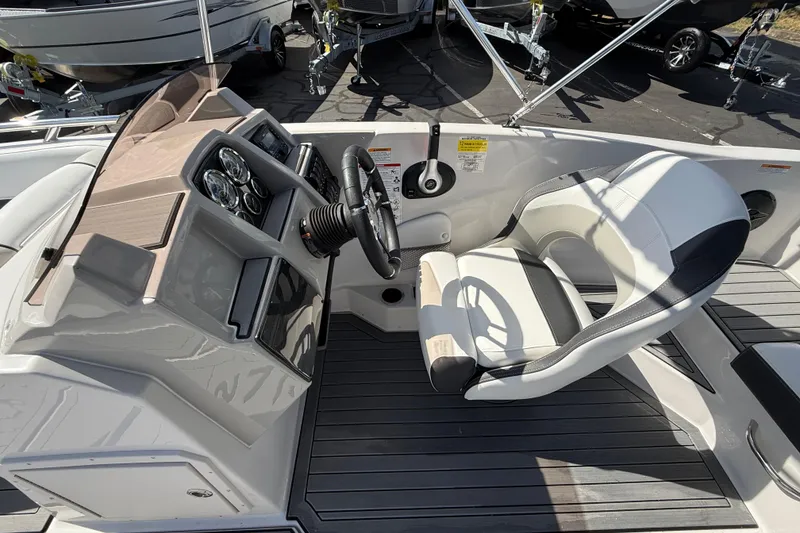 Slide: The Image of 2026 Starcraft SVX 191 OB boat cockpit with steering wheel and comfortable seating. - 6