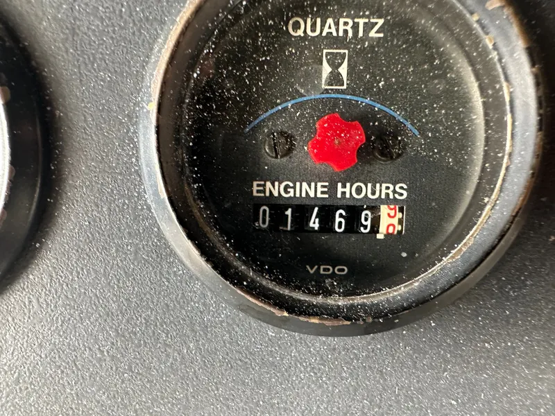 Slide: The Image of 1993 Carver Cruiser 440 engine hour meter showing 1469 hours. - 12