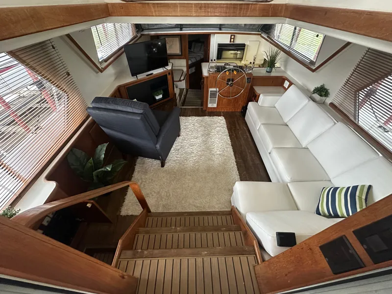 Slide: The Image of Interior of 1993 Carver Cruiser 440 yacht with white sofa and helm station. - 21