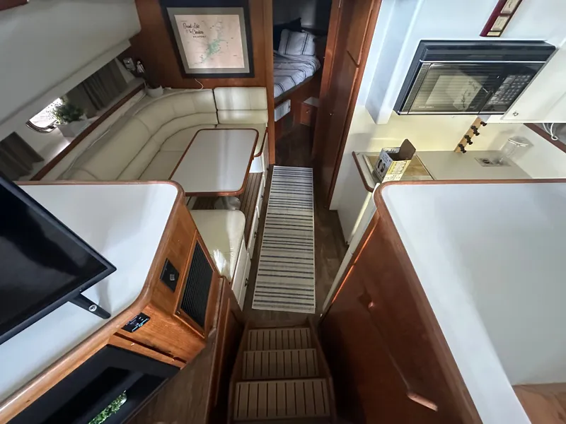 Slide: The Image of Interior of a 1993 Carver Cruiser 440 yacht with kitchen and seating area. - 25