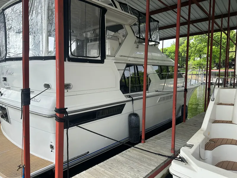 Slide: The Image of 1993 Carver Cruiser 440 yacht docked in marina. - 3