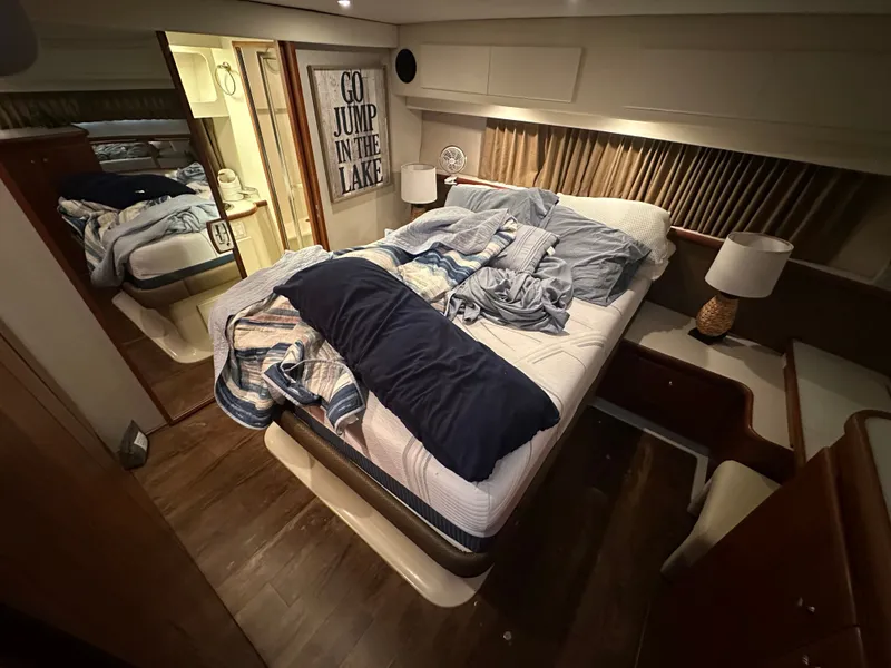 Slide: The Image of Interior of a Carver Cruiser 440 yacht featuring a cozy bedroom. - 35