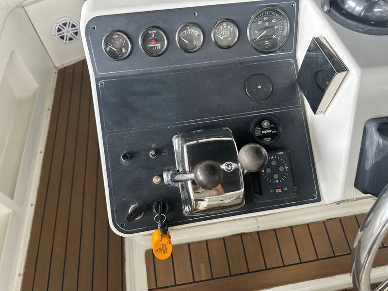 Slide: The Image of Dashboard of a 1993 Carver Cruiser 440 with throttle and gauges. - 9