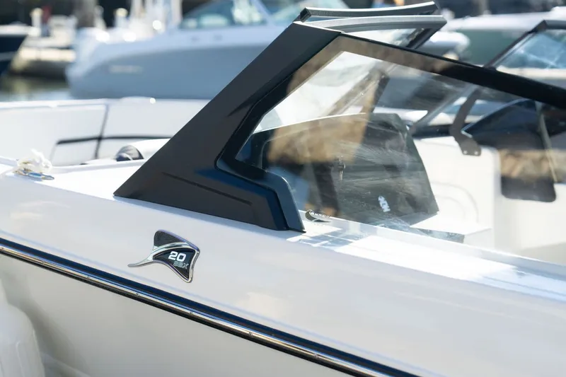 Slide: The Image of 2026 Stingray 20 SBX boat with sleek design at the marina. - 7