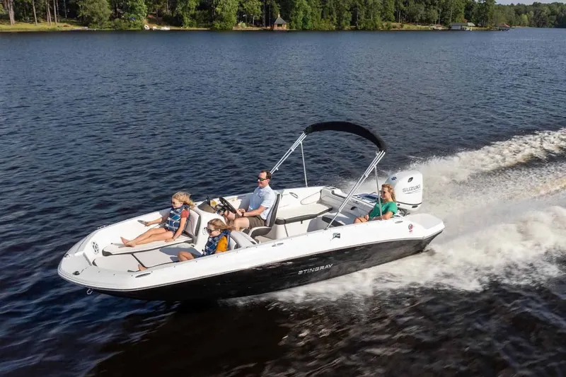 Slide: The Image of Stingray 182 SC 2026 boat cruising on a serene lake with passengers. - 14
