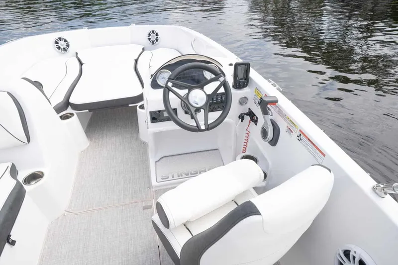 Slide: The Image of Interior of 2026 Stingray 182 SC boat on calm water. - 5