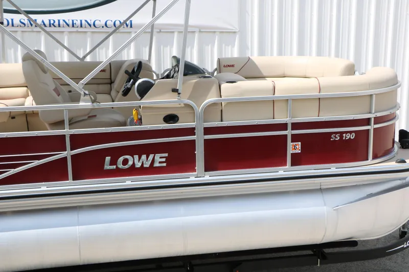 Slide: The Image of 2016 Lowe SS 190 pontoon boat with red exterior and beige seating. - 14