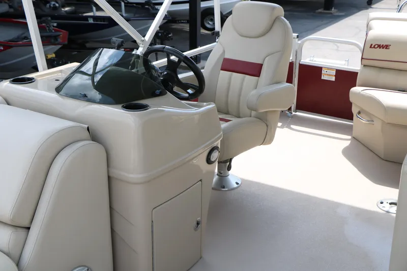 Slide: The Image of Interior of a 2016 Lowe SS 190 boat featuring beige seating and steering console. - 19