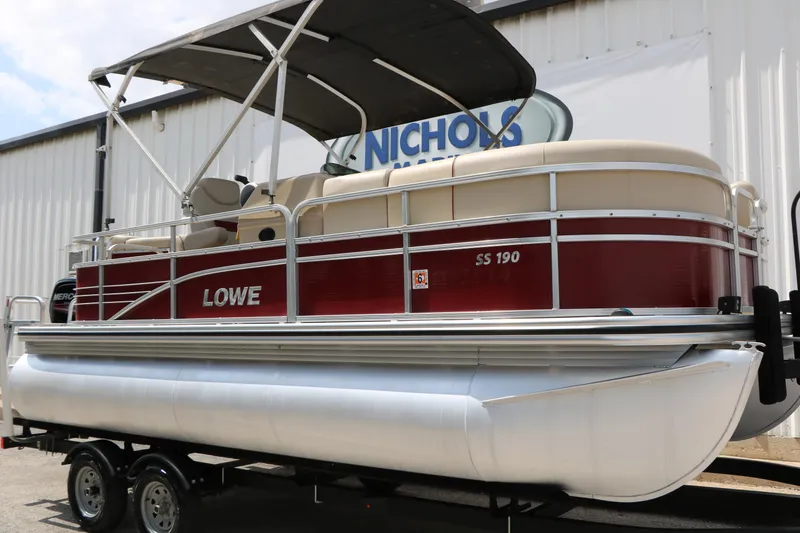 Slide: The Image of 2016 Lowe SS 190 pontoon boat with red and white design on a trailer. - 2
