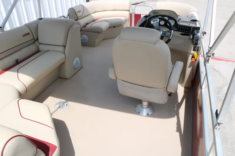 Slide: The Image of Interior of a 2016 Lowe SS 190 boat with beige seating and steering console. - 20