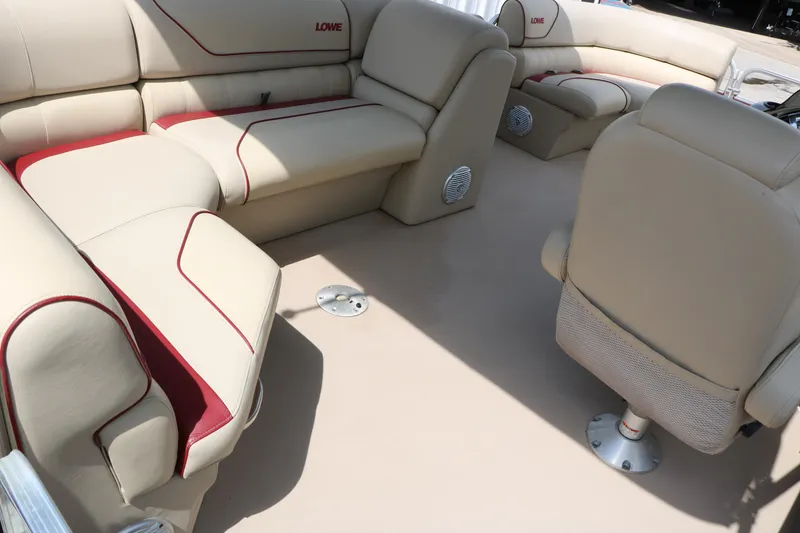 Slide: The Image of Interior of a 2016 Lowe SS 190 boat with beige seating and red accents. - 21