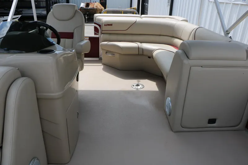 Slide: The Image of Interior of a 2016 Lowe SS 190 boat with beige seating and steering console. - 28