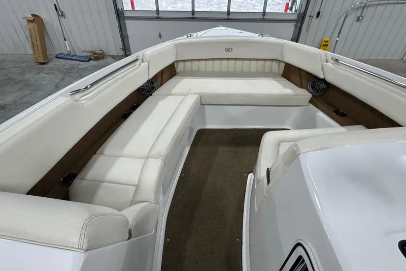 Slide: The Image of Interior of a 2018 Cobalt boat with white cushioned seating and brown accents. - 14