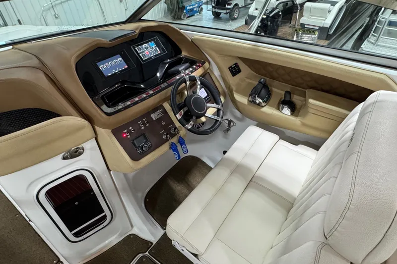 Slide: The Image of 2018 Cobalt boat interior with modern dashboard and beige seating. - 15