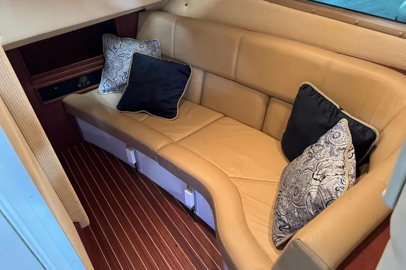 Slide: The Image of Luxurious 2018 Cobalt boat interior with tan leather seating and decorative pillows. - 18