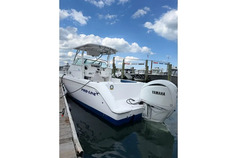 Slide: The Image of 2001 Pro-Line 260 Walkaround boat docked with Yamaha outboard motor. - 4