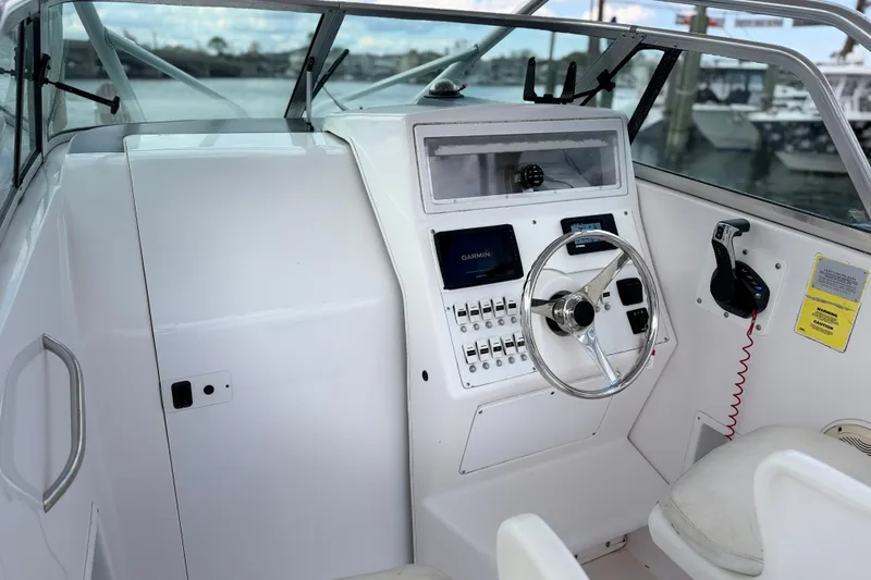 Slide: The Image of 2001 Pro-Line 260 Walkaround boat cockpit with steering wheel and navigation controls. - 6
