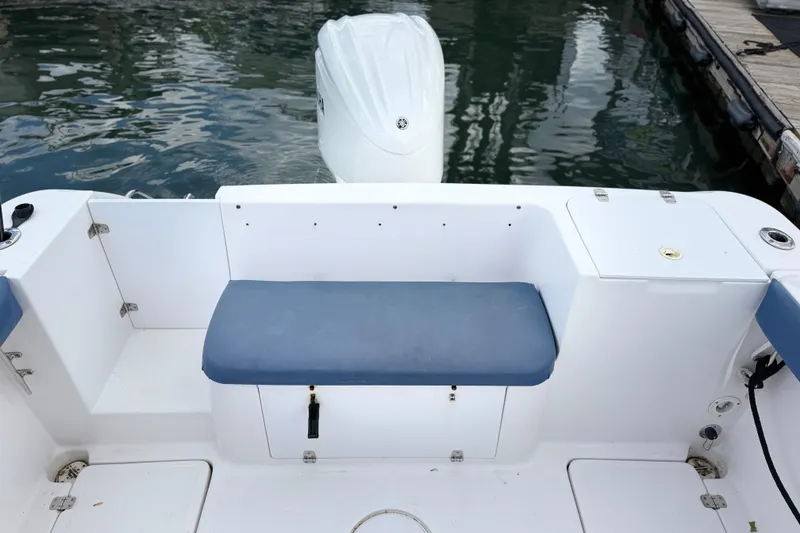 Slide: The Image of 2001 Pro-Line 260 Walkaround boat interior with cushioned seating and outboard motor. - 7