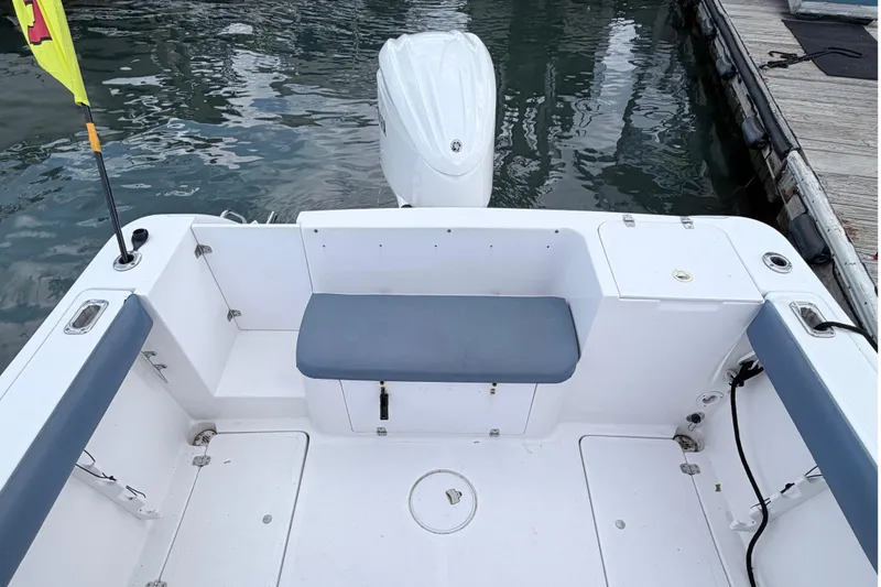 Slide: The Image of 2001 Pro-Line 260 Walkaround boat interior with seating and outboard motor at dock. - 8