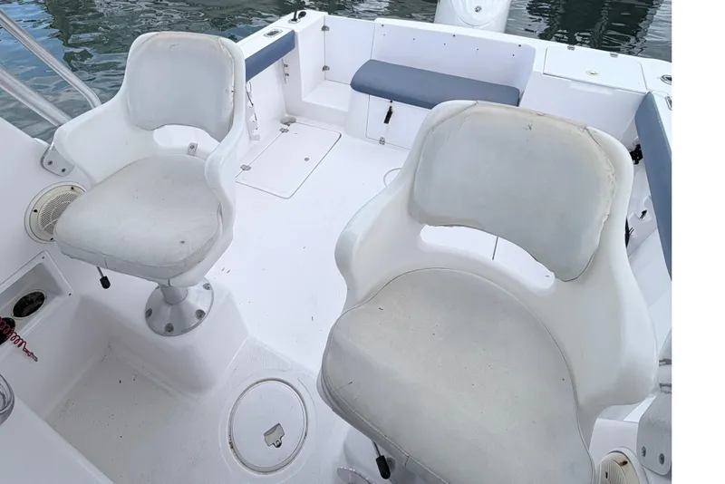 Slide: The Image of 2001 Pro-Line 260 Walkaround boat interior with white seating and deck. - 9