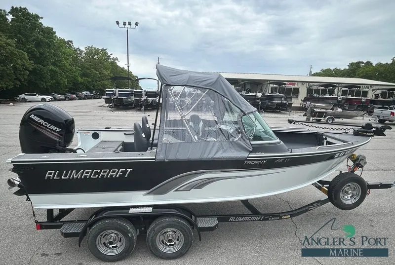 The Image of 2013 Alumacraft Trophy 195 boat on trailer outdoors. - 1
