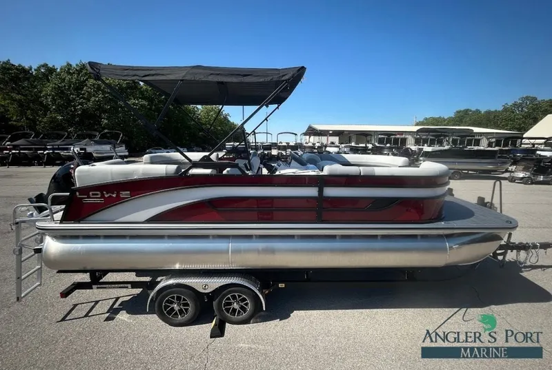 The Image of 2026 Lowe SS230 WV pontoon boat on trailer outdoors. - 1