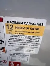 Slide: The Image of Capacity label for 12 persons or 1910 lbs on 2024 Lowe SS230 WV. - 16