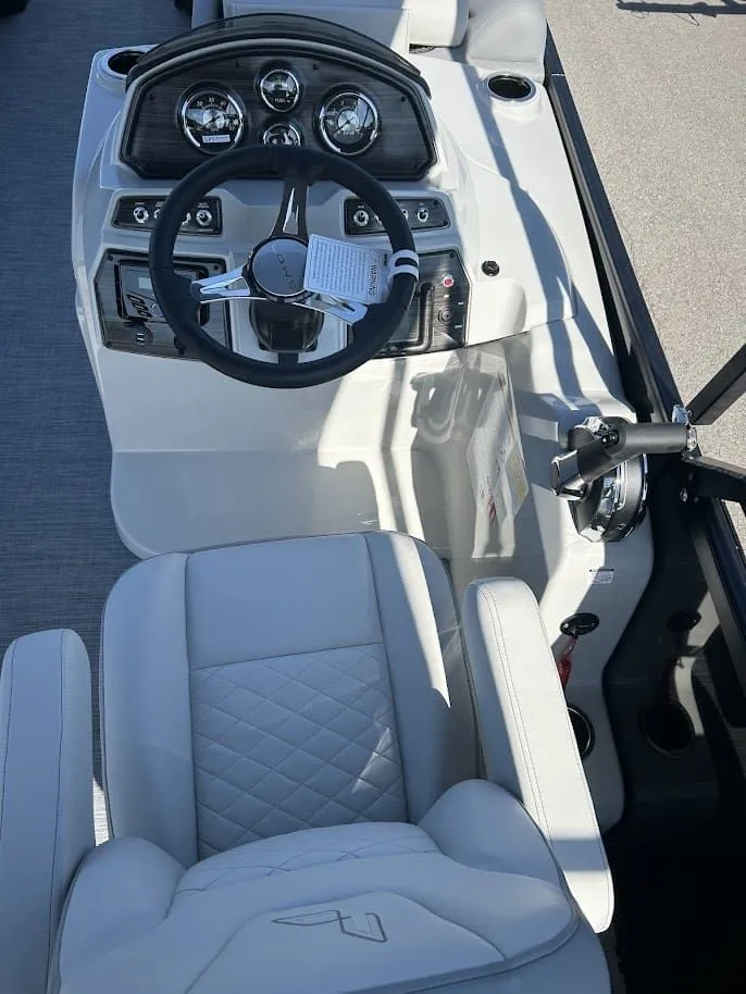 Slide: The Image of Interior view of 2024 Lowe SS230 WV boat cockpit with steering wheel and instruments. - 9