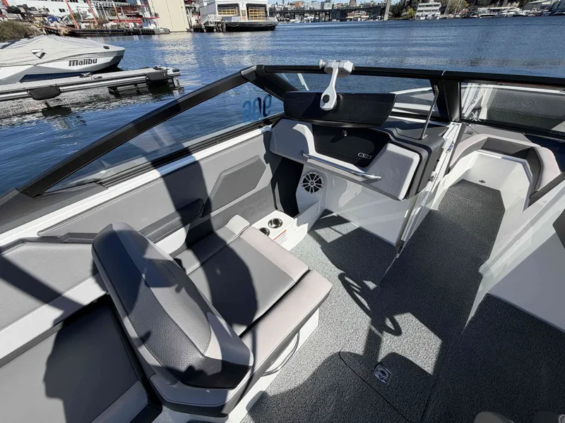 Slide: The Image of Interior of 2025 Cobalt CS23 Surf boat by the water. - 13