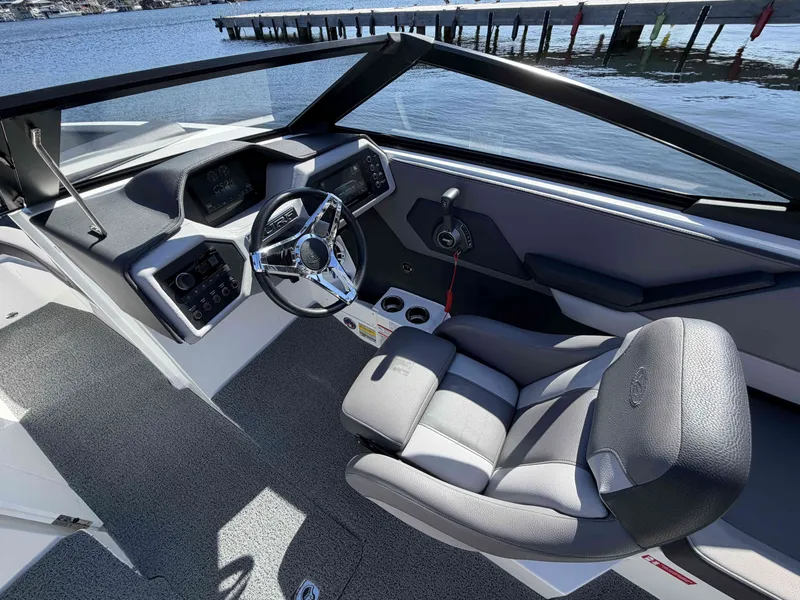 Slide: The Image of Interior of 2025 Cobalt CS23 Surf boat by the water. - 14