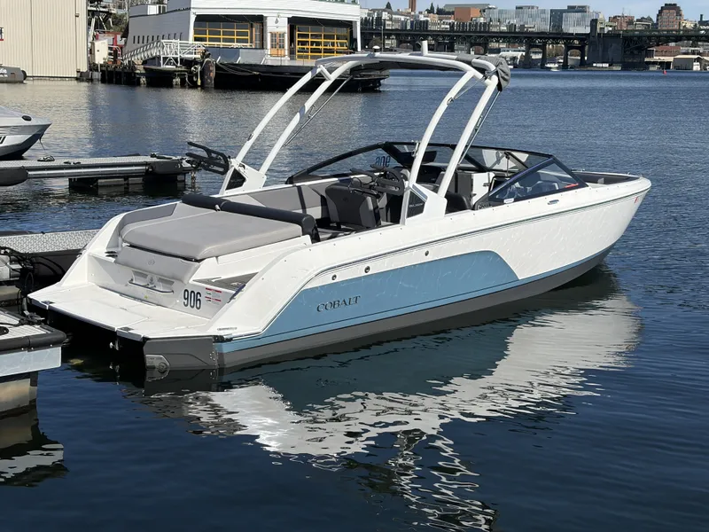 Slide: The Image of 2025 Cobalt CS23 Surf boat docked at harbor. - 4
