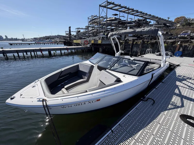 Slide: The Image of 2025 Cobalt CS23 Surf boat docked on a sunny day. - 7