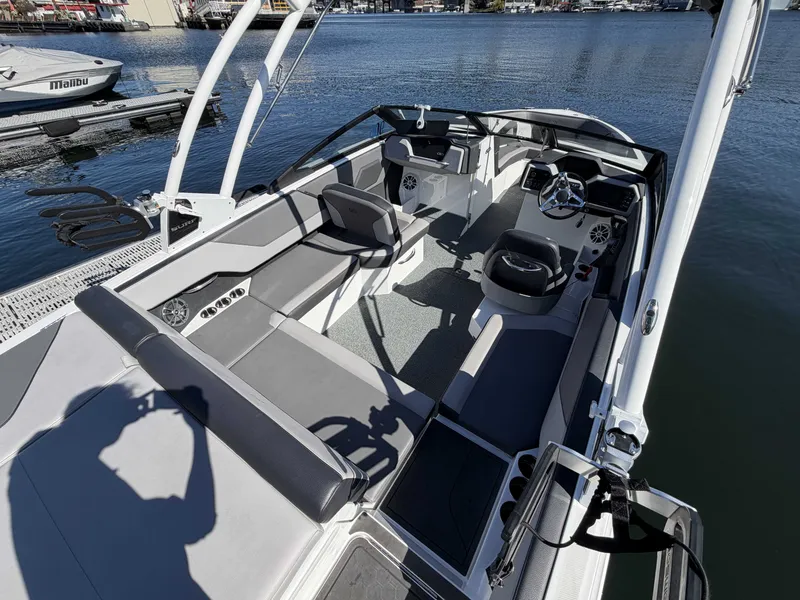 Slide: The Image of Interior view of 2025 Cobalt CS23 Surf boat by the water. - 9
