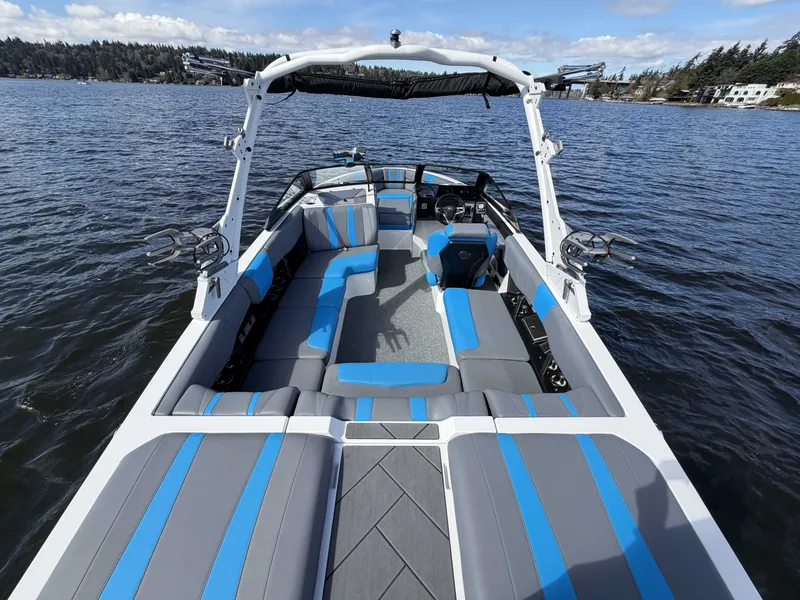 Slide: The Image of 2025 Malibu Wakesetter 22 LSV on a serene lake. - 11