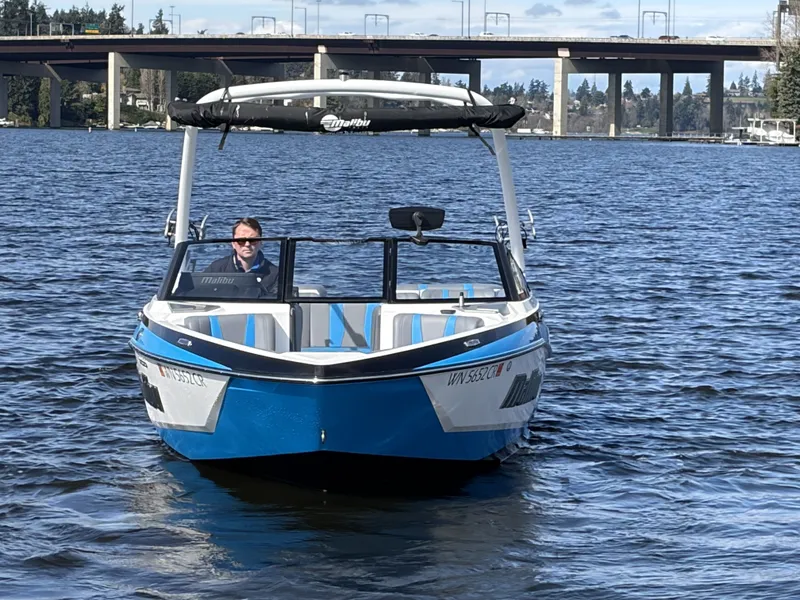 Slide: The Image of 2025 Malibu Wakesetter 22 LSV on a calm lake. - 2