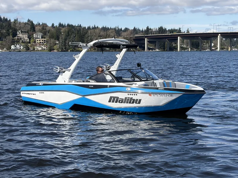 Slide: The Image of 2025 Malibu Wakesetter 22 LSV on a calm lake. - 4