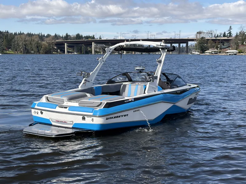 Slide: The Image of 2025 Malibu Wakesetter 22 LSV on a serene lake. - 6