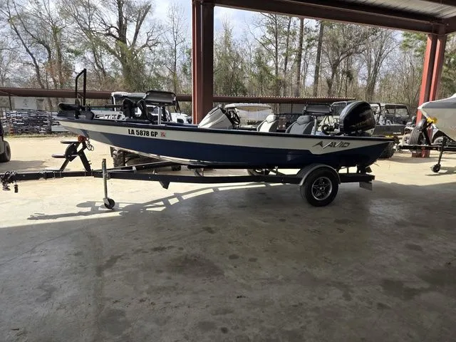 Slide: The Image of 2022 Avid 18 XB boat on trailer in warehouse. - 3