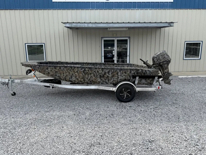 The Image of 2026 Thor Fish Hammer boat with camouflage design and trailer. - 1