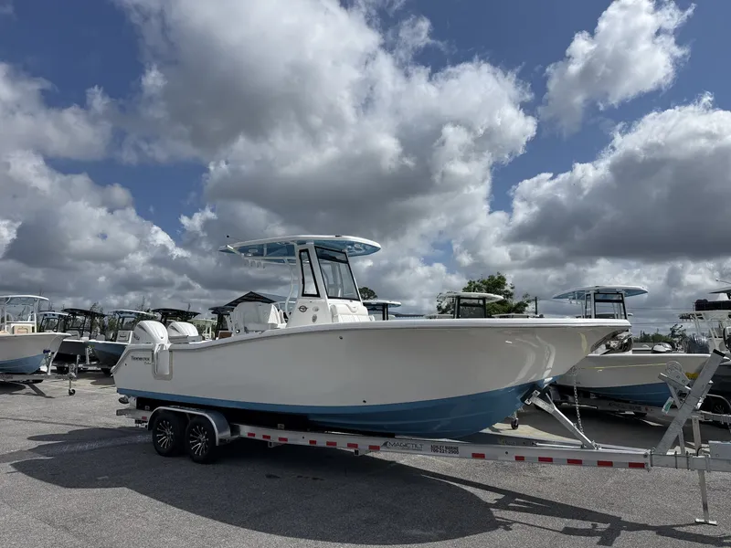The Image of 2026 Tidewater 272 CC Adventure boat on trailer under cloudy sky. - 1